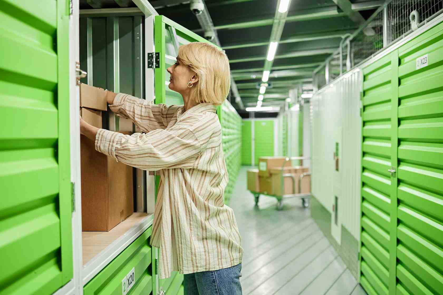 Middle-aged woman placing cardboard box from Amazon Wholesale Suppliers in USA